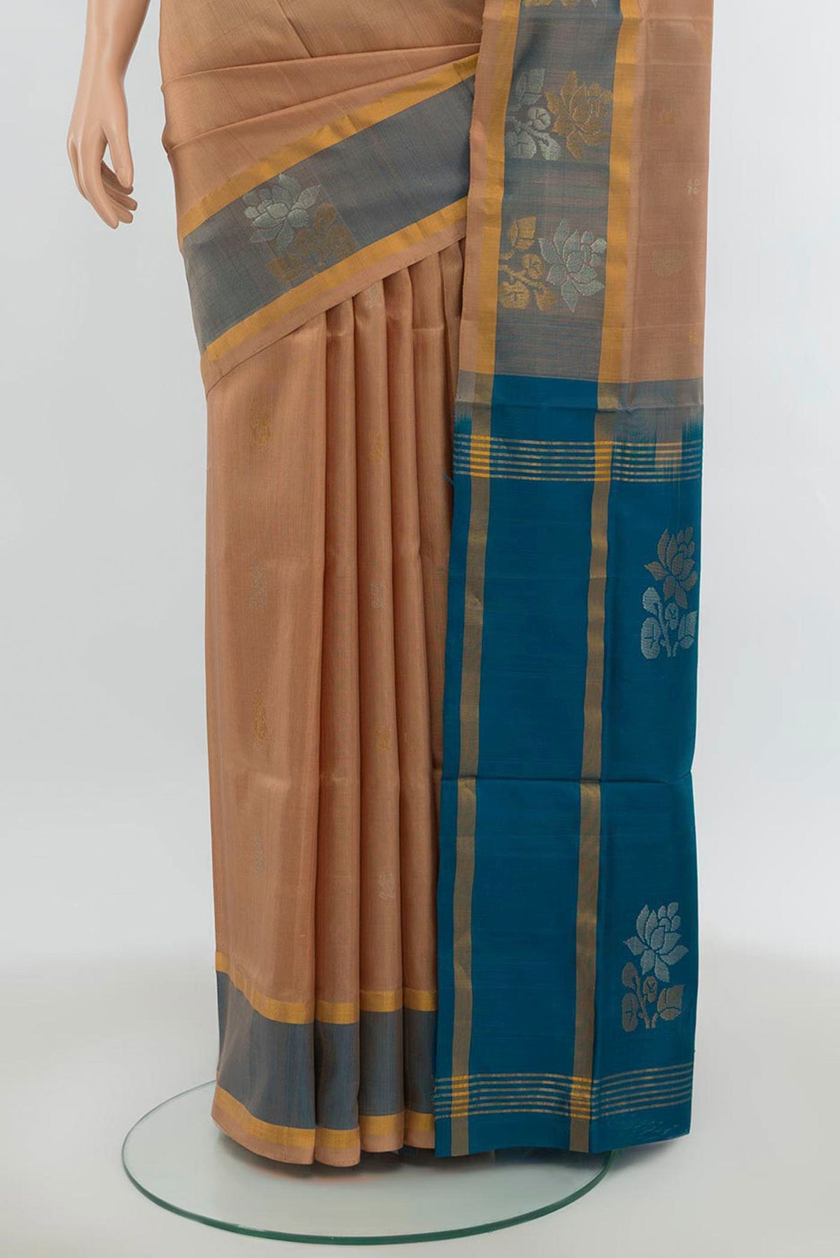 Pleats and pallu of Beige Uppada Silk Saree with Zari Butta on the body and Silk Border. 