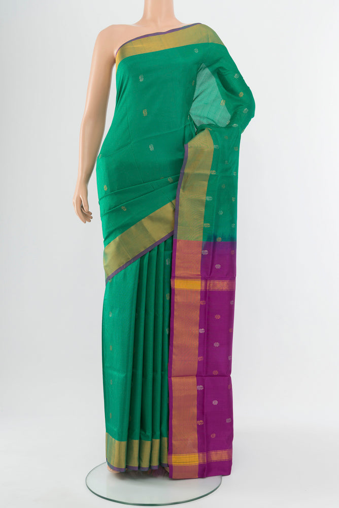 Peacock Blue Uppada Silk Saree with Zari Butta on the body and Silk Border.  displayed on a mannequin
