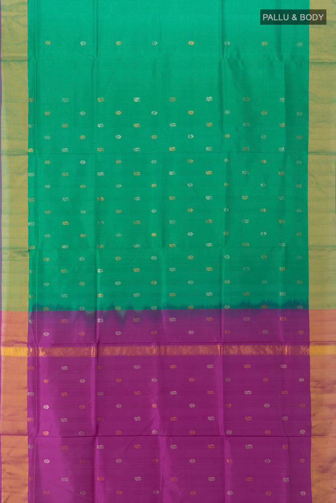 Flat view of Peacock Blue Uppada Silk Saree with Zari Butta on the body and Silk Border. 
