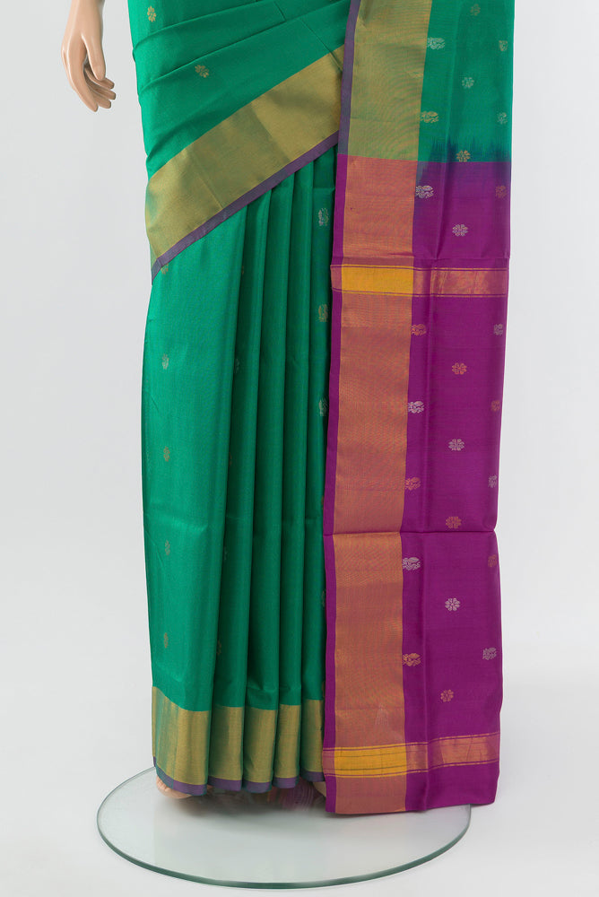 Pleats and pallu of Peacock Blue Uppada Silk Saree with Zari Butta on the body and Silk Border. 