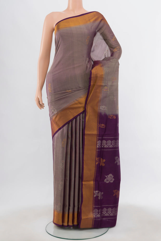 Bronze Uppada Silk Saree with Zari Butta on the body and Silk Border.  displayed on a mannequin