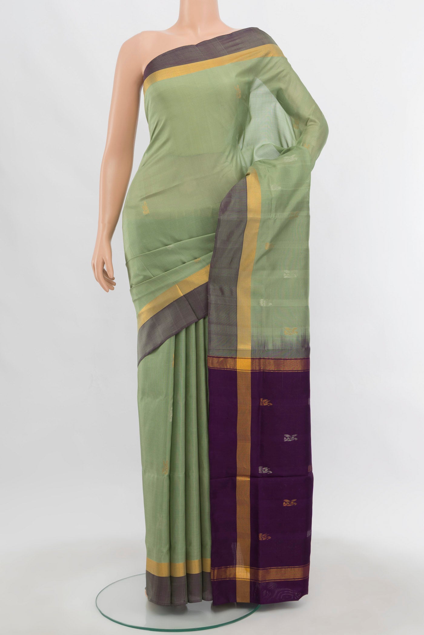 Pista Green Uppada Silk Saree with Zari Butta on the body and Zari Border.  displayed on a mannequin