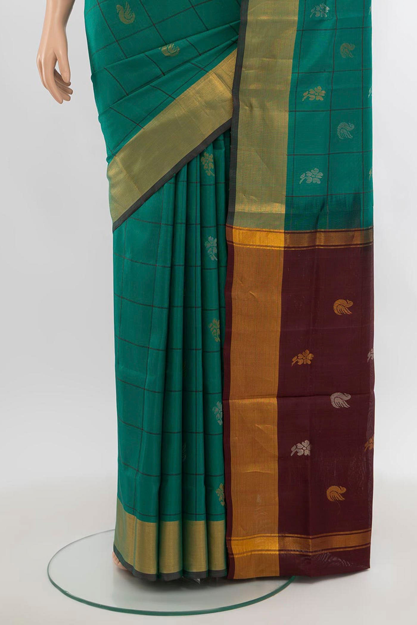 Pleats and pallu of Pure Silk Pure Zari Peacock Blue Uppada Saree with Zari Butta on the body and Silk Border. 