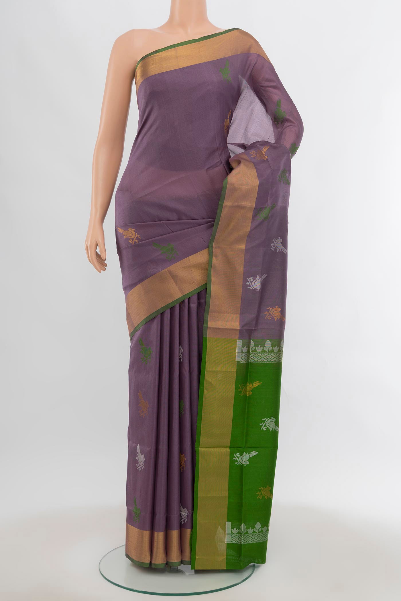 Saffron Uppada Silk Saree with Zari Butta on the body and Silk Border.  displayed on a mannequin