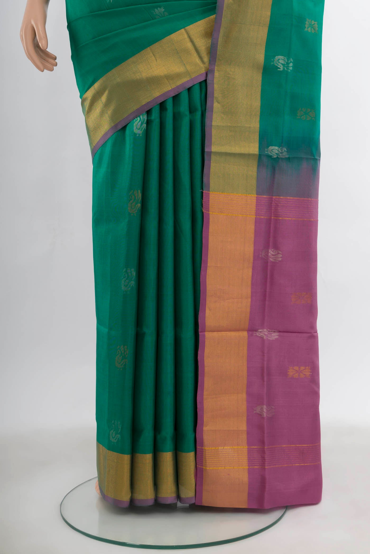 Pleats and pallu of Peacock Blue Uppada Silk Saree with Zari Butta on the body and Silk Border. 