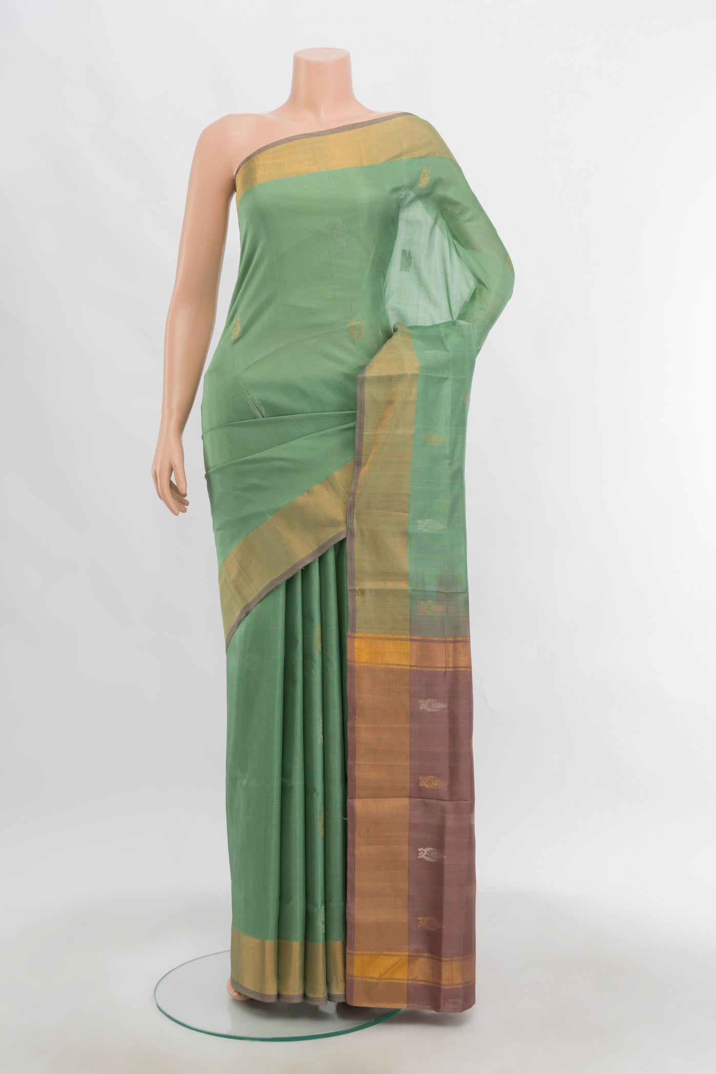 Pista Green Uppada Silk Saree with Zari Butta on the body and Zari Border.  displayed on a mannequin