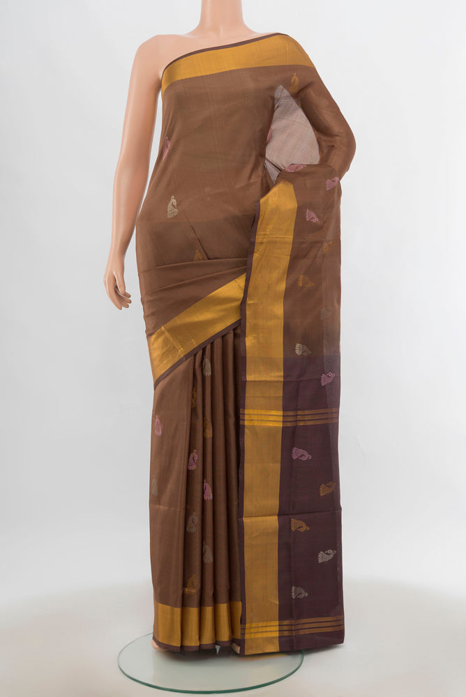 Brown Uppada Silk Saree with Zari Butta on the body and Silk Border.  displayed on a mannequin