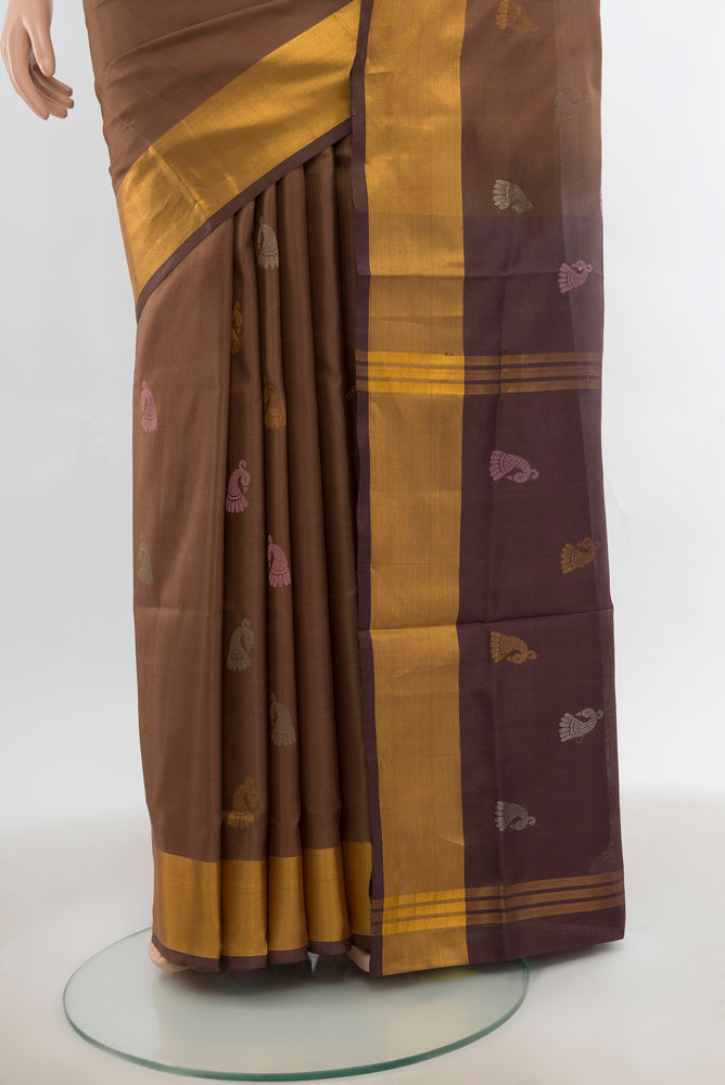 Pleats and pallu of Brown Uppada Silk Saree with Zari Butta on the body and Silk Border. 