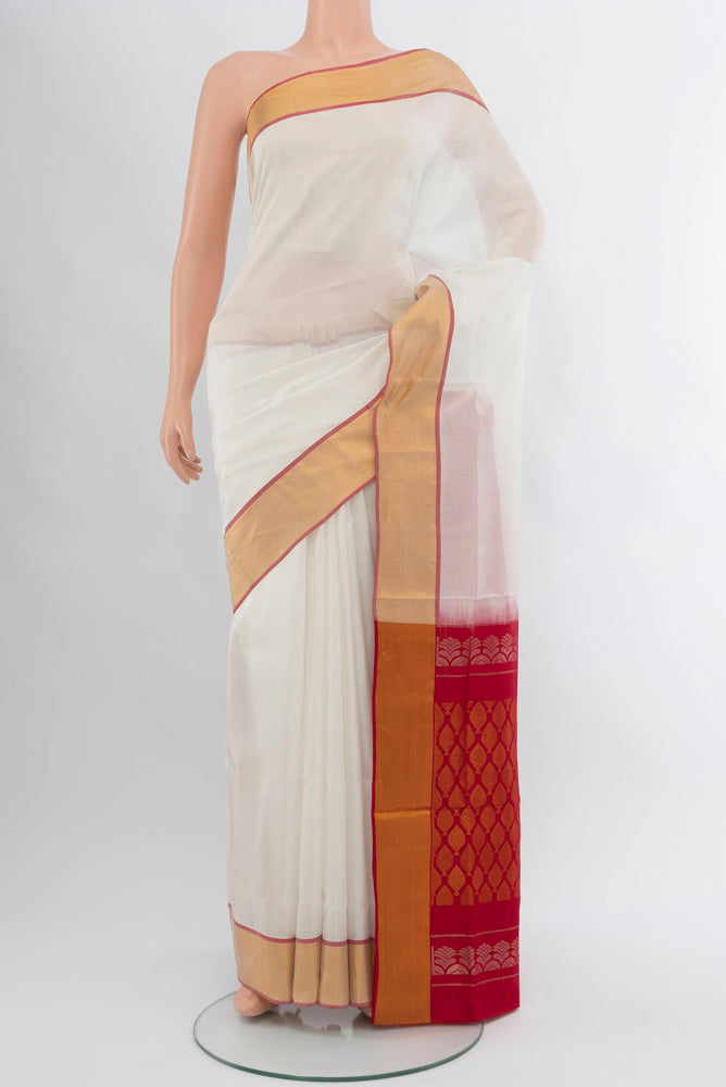 Off White Uppada Silk Saree with Zari Butta on the body and Silk Border.  displayed on a mannequin