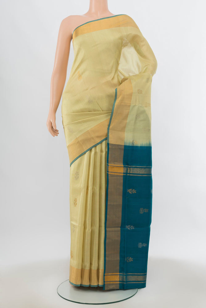 Cream Uppada Silk Saree with Zari Butta on the body and Silk Border.  displayed on a mannequin