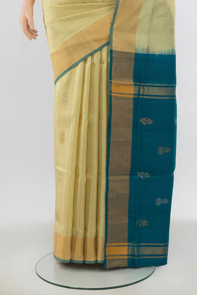 Pleats and pallu of Cream Uppada Silk Saree with Zari Butta on the body and Silk Border. 