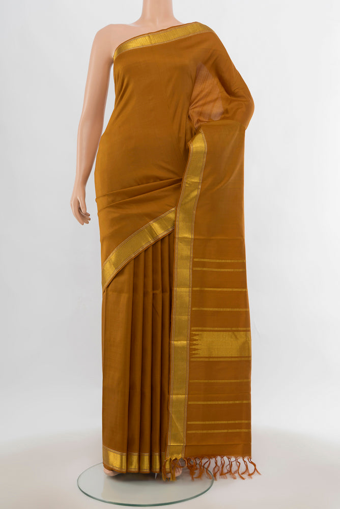 Brown Kanjivaram Silk Saree with Plain Body and Silk Border.  displayed on a mannequin