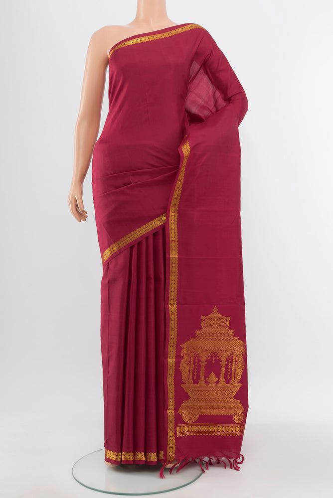 Pure Silk Pure Zari Maroon Kanjivaram Saree with Zari Butta on the body and Silk Border.  displayed on a mannequin