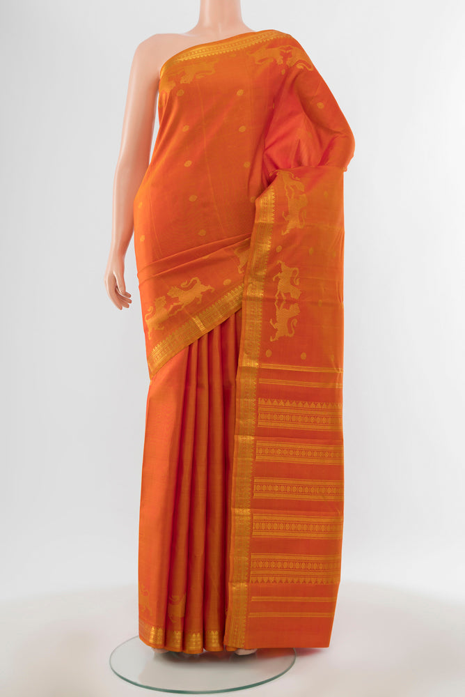 Pure Silk Pure Zari Brick Orange Kanjivaram Saree with Zari Butta on the body and Silk Border.  displayed on a mannequin