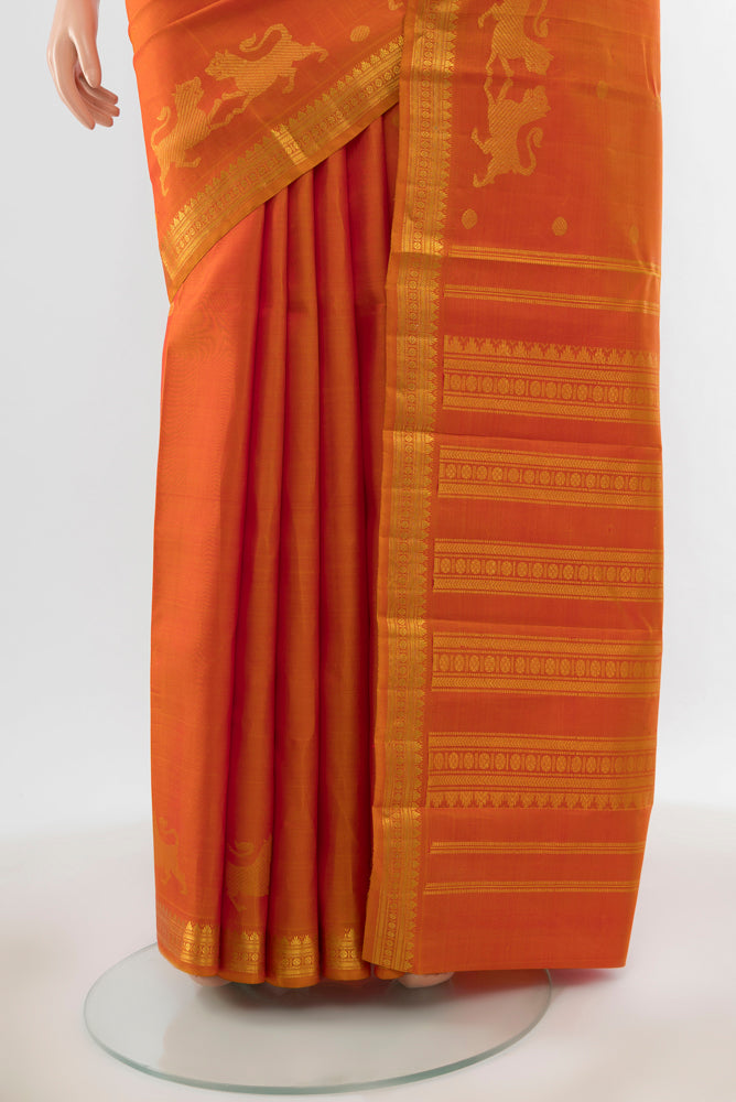 Pleats and pallu of Pure Silk Pure Zari Brick Orange Kanjivaram Saree with Zari Butta on the body and Silk Border. 