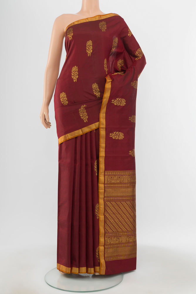 Pure Silk Pure Zari Maroon Kanchipuram Saree with Zari Butta on the body and Silk Border.  displayed on a mannequin