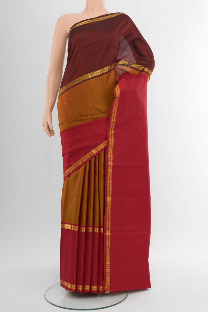 Pure Silk Pure Zari Multi Color Kanjivaram Saree with Zari Butta on the body and Silk Border.  displayed on a mannequin