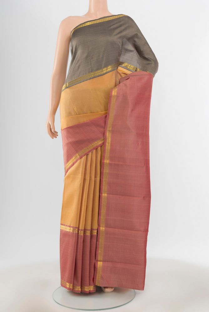 Pure Silk Pure Zari Multi Color Kanjivaram Saree with Zari Butta on the body and Silk Border.  displayed on a mannequin