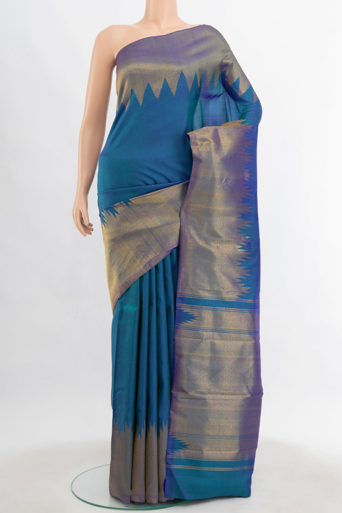 Pure Silk Pure Zari Peacock Blue Kanchipuram Saree with Zari Butta on the body and Silk Border.  displayed on a mannequin