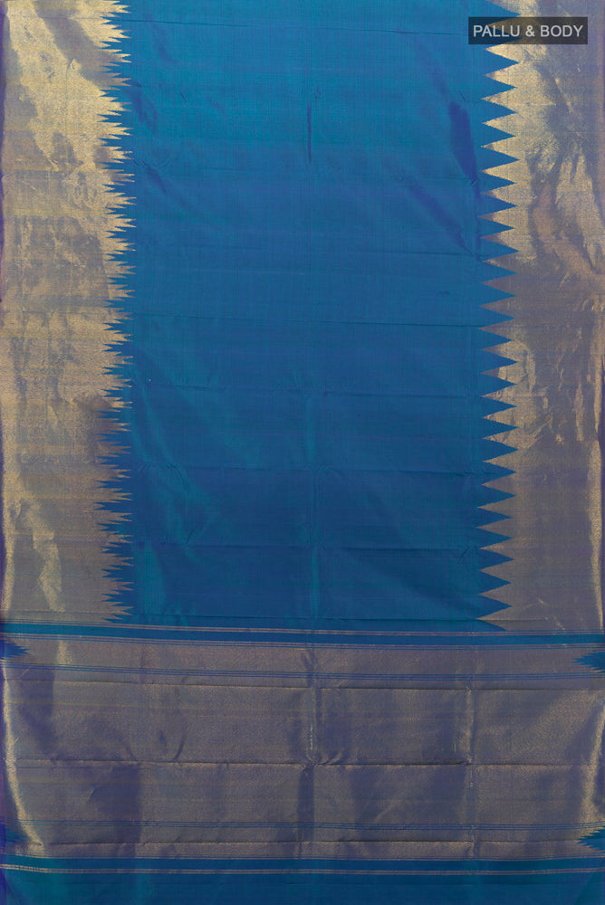 Flat view of Pure Silk Pure Zari Peacock Blue Kanchipuram Saree with Zari Butta on the body and Silk Border. 