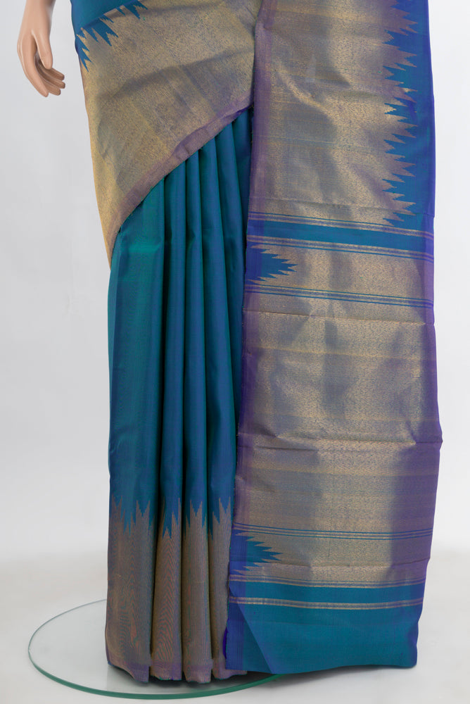 Pleats and pallu of Pure Silk Pure Zari Peacock Blue Kanchipuram Saree with Zari Butta on the body and Silk Border. 