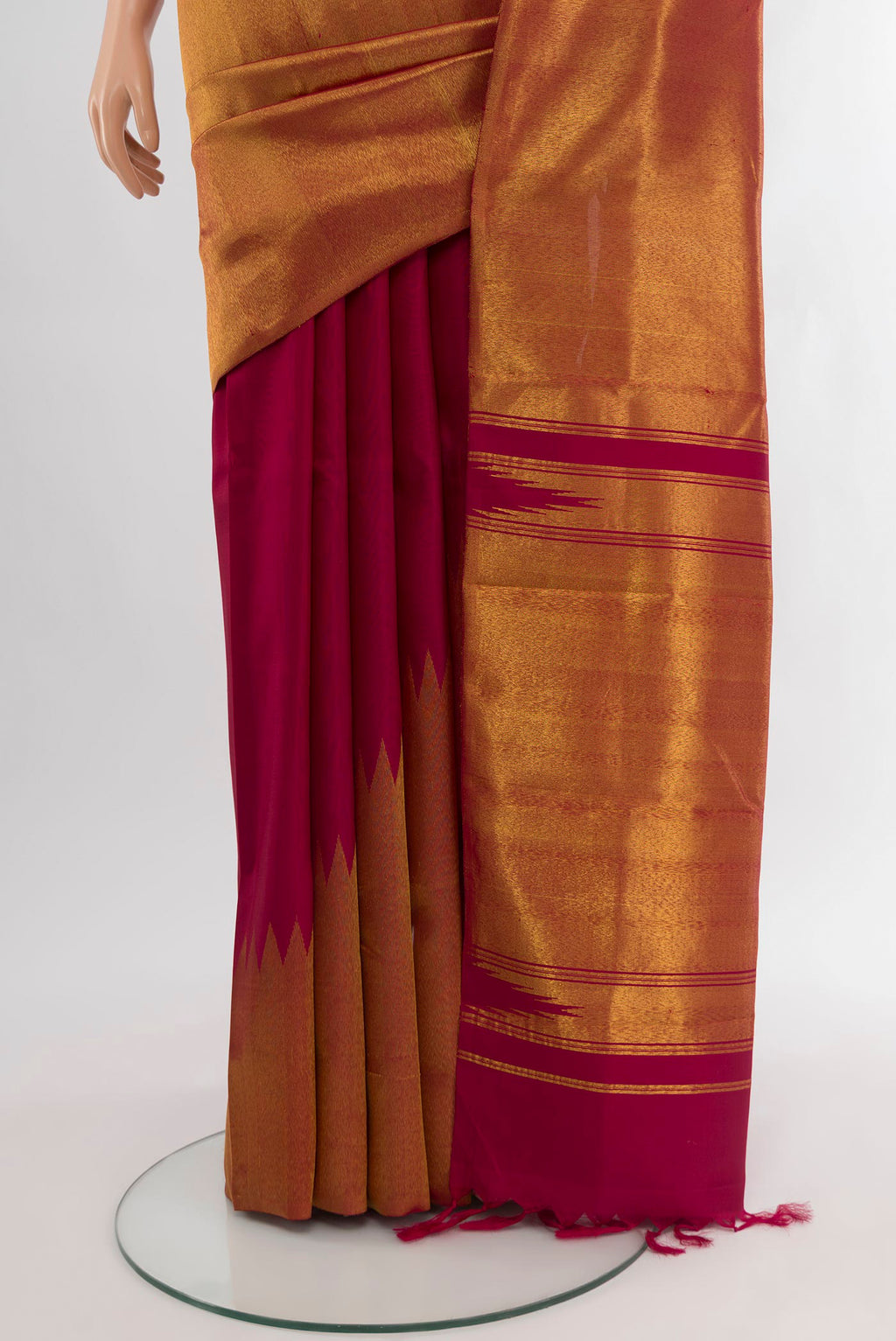 Pleats and pallu of Maroon Kanchipuram Silk Saree with Plain Body and Rising Temple Border. 