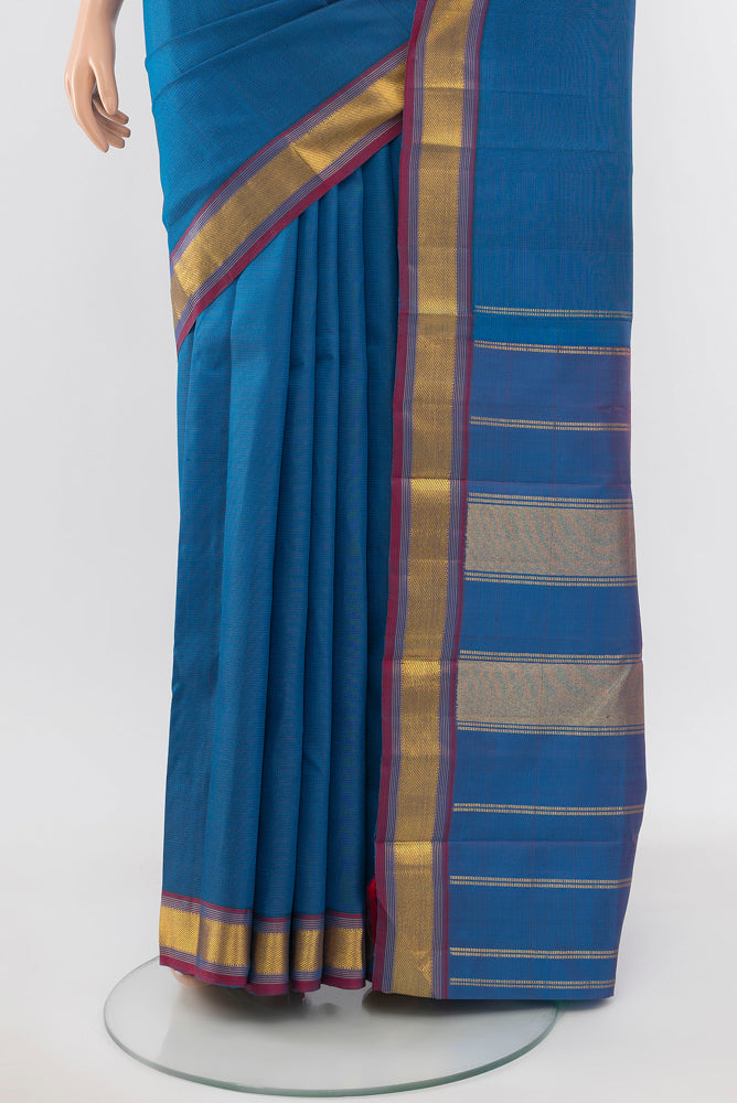 Pleats and pallu of Light Blue Kanchipuram Silk Saree with Zari Butta on the body and Silk Border. 
