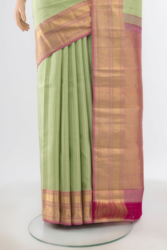 Pleats and pallu of Pista Green Kanchipuram Silk Saree with Zari Butta on the body and Silk Border. 