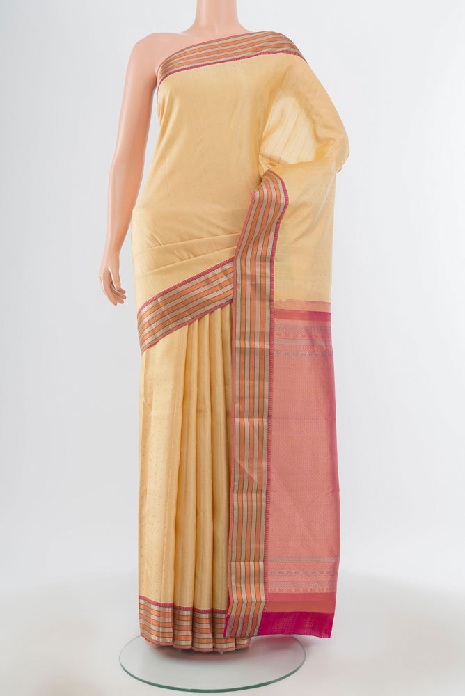 Pure Silk Pure Zari Beige Kanchipuram Saree with Zari Butta on the body and Silk Border.  displayed on a mannequin