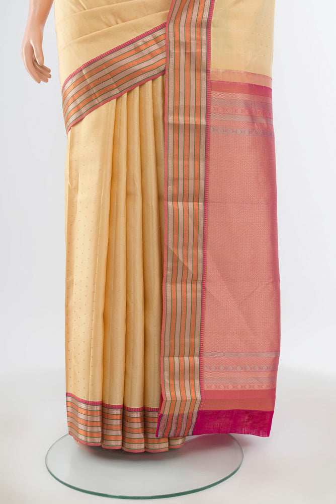 Pleats and pallu of Pure Silk Pure Zari Beige Kanchipuram Saree with Zari Butta on the body and Silk Border. 