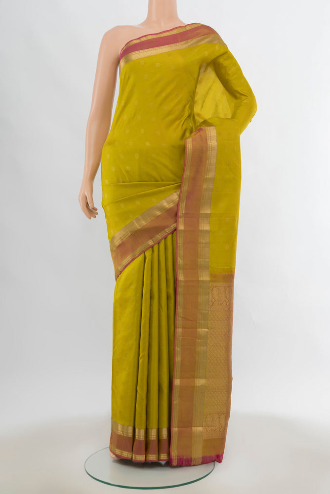 Pure Silk Pure Zari Mehandi Green Kanchipuram Saree with Zari Butta on the body and Silk Border.  displayed on a mannequin