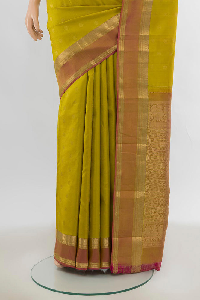 Pleats and pallu of Pure Silk Pure Zari Mehandi Green Kanchipuram Saree with Zari Butta on the body and Silk Border. 