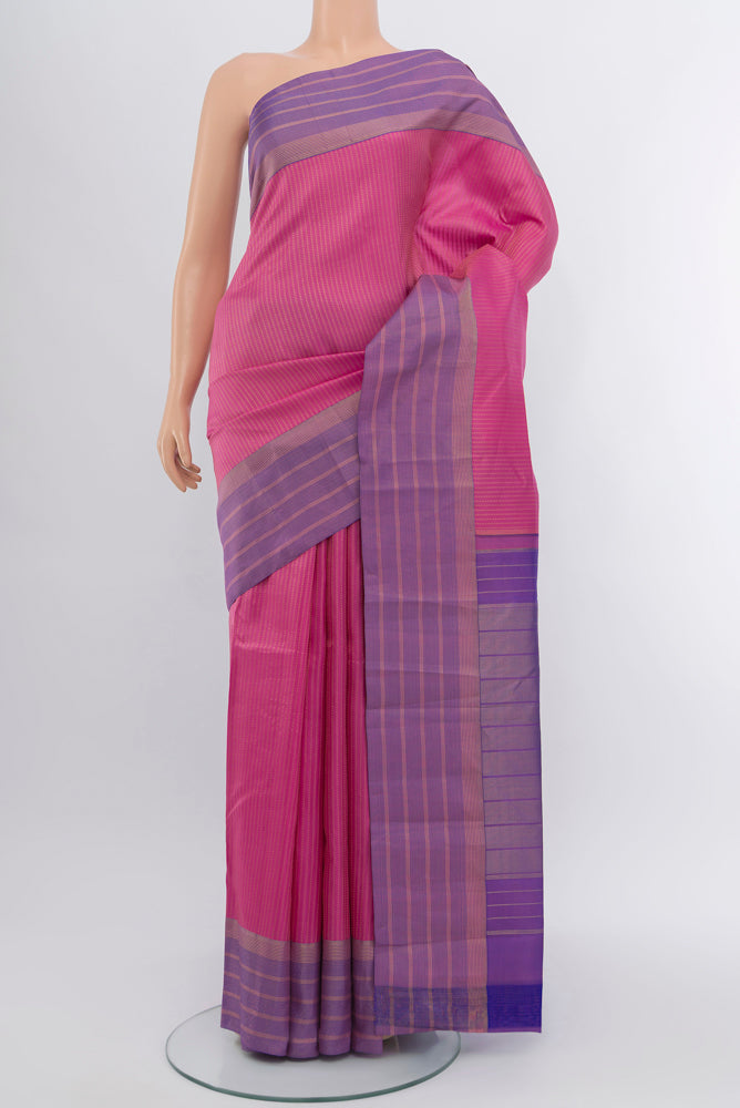 Rose Gold Kanchipuram Silk Saree with Zari Butta on the body and Silk Border.  displayed on a mannequin