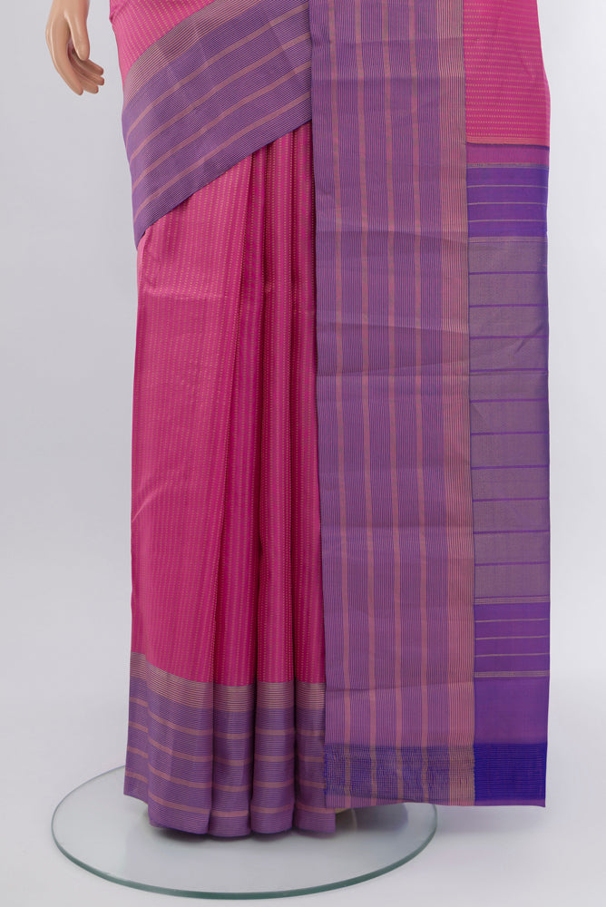 Pleats and pallu of Rose Gold Kanchipuram Silk Saree with Zari Butta on the body and Silk Border. 