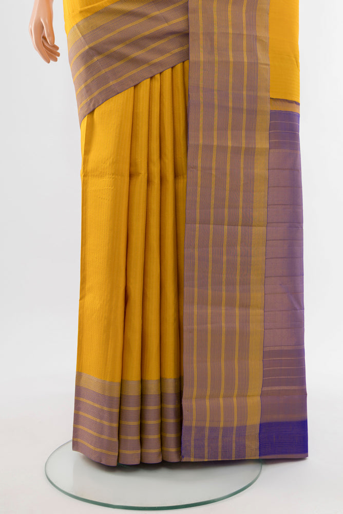 Pleats and pallu of Mustard Kanchipuram Silk Saree with Zari Butta on the body and Silk Border. 