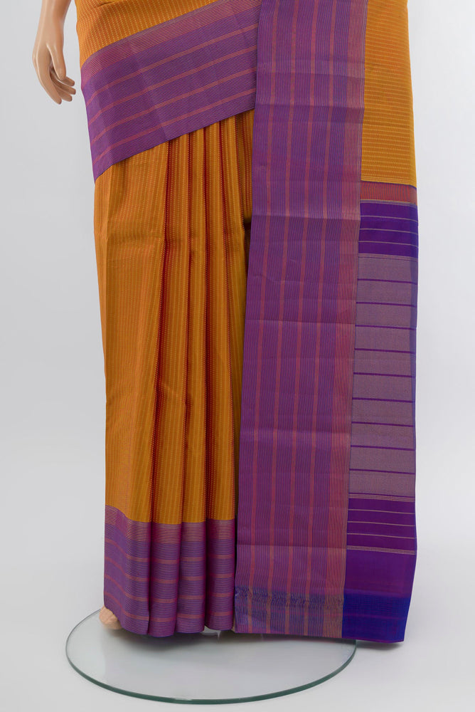 Pleats and pallu of Rust Kanchipuram Silk Saree with Zari Butta on the body and Silk Border. 