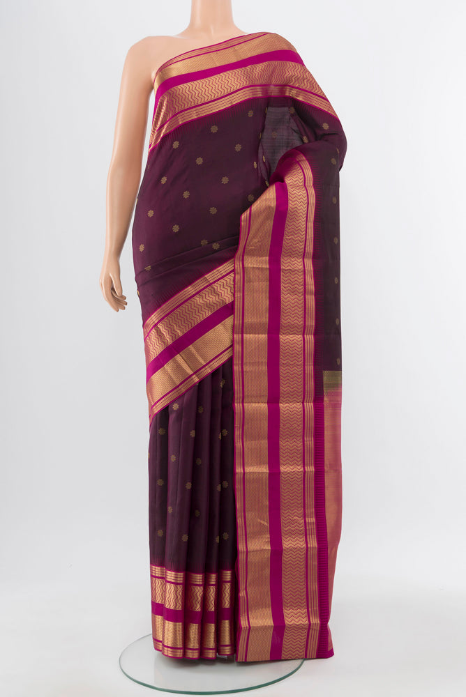 Pure Silk Pure Zari Brown Kanjivaram Saree with Zari Butta on the body and Silk Border.  displayed on a mannequin