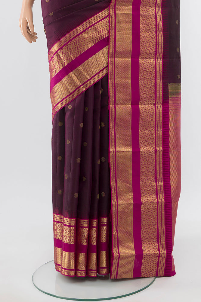 Pleats and pallu of Pure Silk Pure Zari Brown Kanjivaram Saree with Zari Butta on the body and Silk Border. 