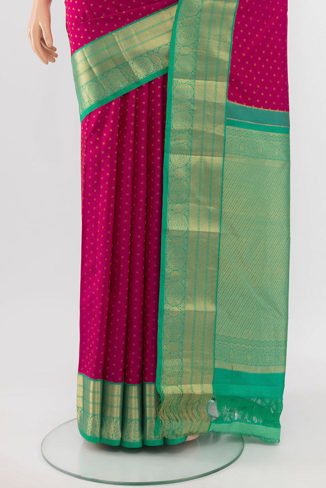 Pleats and pallu of Dark Pink Kanchipuram Silk Saree with Zari Butta on the body and Silk Border. 