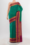 Peacock Blue Kanchipuram Silk Saree with Zari Butta on the body and Silk Border.  displayed on a mannequin