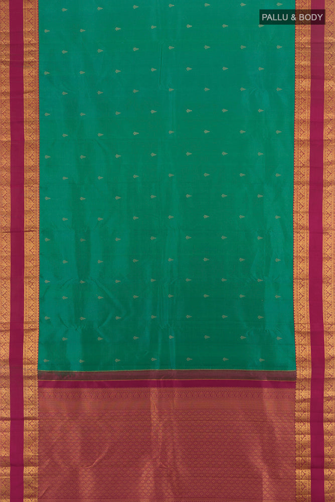 Flat view of Peacock Blue Kanchipuram Silk Saree with Zari Butta on the body and Silk Border. 