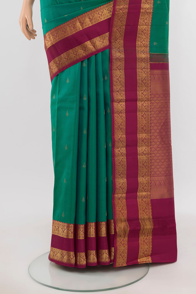 Pleats and pallu of Peacock Blue Kanchipuram Silk Saree with Zari Butta on the body and Silk Border. 