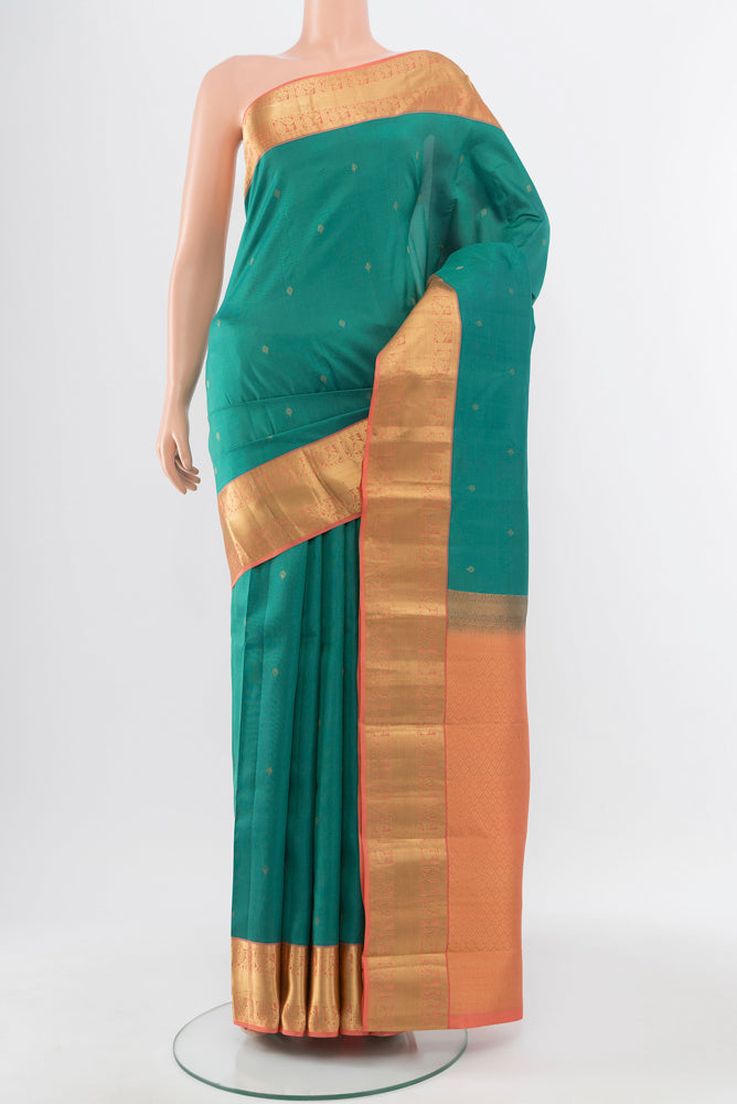 Pure Silk Pure Zari Sea Green Kanchipuram Saree with Zari Butta on the body and Silk Border.  displayed on a mannequin