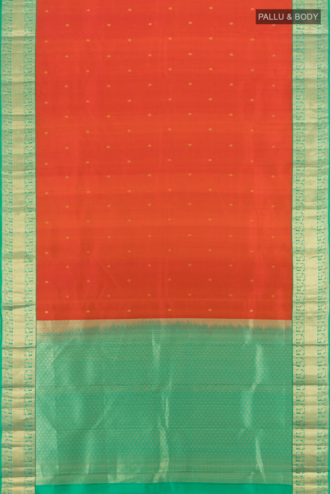 Flat view of Rust Kanchipuram Silk Saree with Zari Butta on the body and Silk Border. 