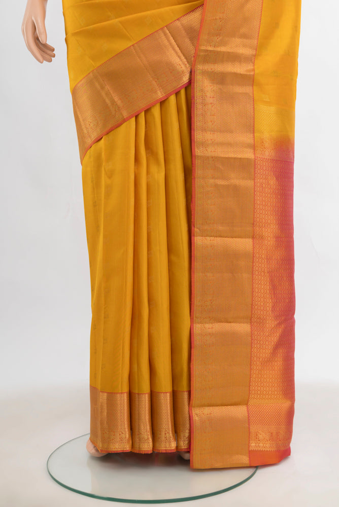 Pleats and pallu of Mustard Kanchipuram Silk Saree with Zari Butta on the body and Silk Border. 