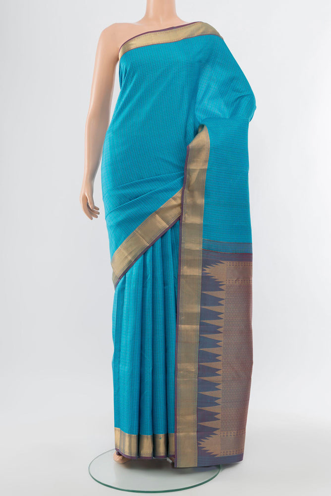 Sky Blue Kanchipuram Silk Saree with Zari Butta on the body and Silk Border.  displayed on a mannequin