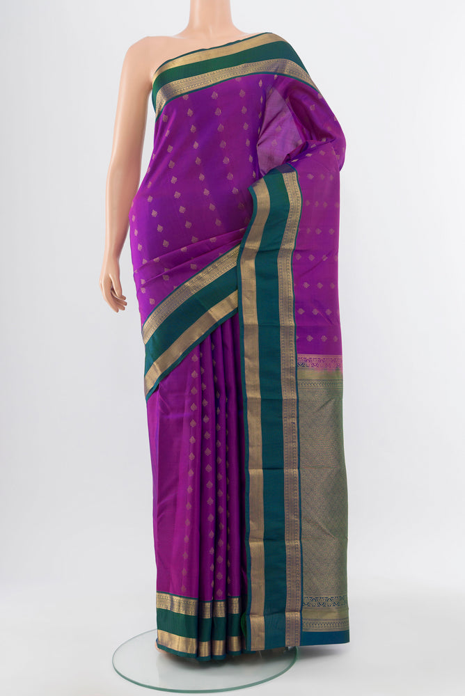 Pure Silk Pure Zari Purple Kanchipuram Saree with Zari Butta on the body and Silk Border.  displayed on a mannequin