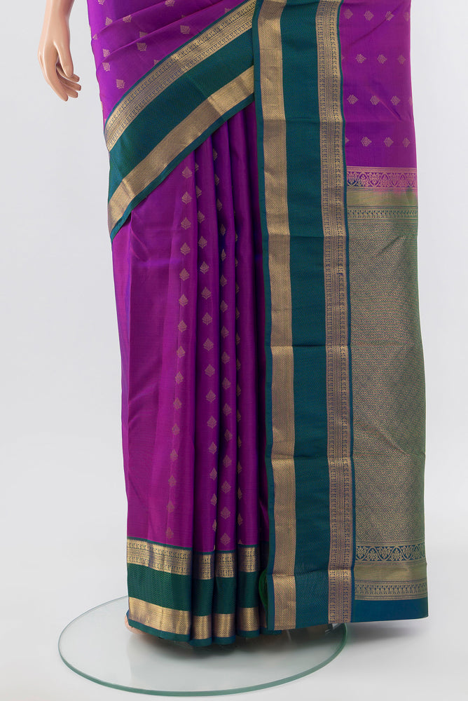 Pleats and pallu of Pure Silk Pure Zari Purple Kanchipuram Saree with Zari Butta on the body and Silk Border. 