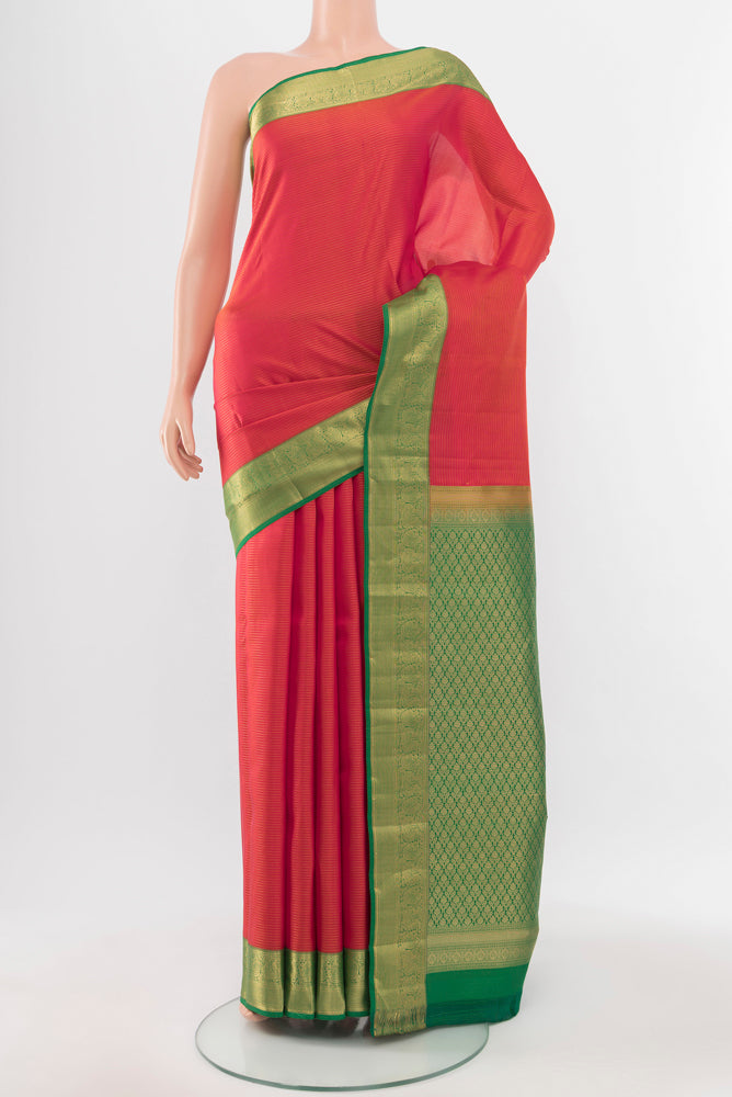 Peach Kanchipuram Silk Saree with Zari Butta on the body and Silk Border.  displayed on a mannequin