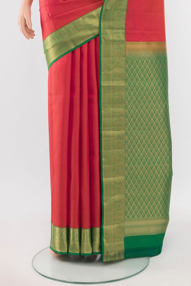 Pleats and pallu of Peach Kanchipuram Silk Saree with Zari Butta on the body and Silk Border. 